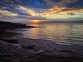 Beautiful sunset at Dead Sea, Jordan. Salt beach. Rays of lights