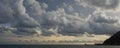 Beautiful sunset and dramatic cloudy sky on a resort beach in Langkawi, Malaysia. Bungalows on the Pacific Ocean. Dramatic clouds Royalty Free Stock Photo