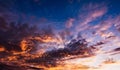 beautiful sunset with dramatic orange clouds in cloudy sky in the evening Royalty Free Stock Photo
