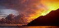 Beautiful sunset and dramatic sky on a resort beach in Langkawi, Malaysia. Bungalows on the Pacific Ocean. Royalty Free Stock Photo