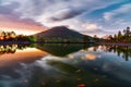 Beautiful sunset on the edge of the lake with views of Mount Dieng