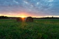 Beautiful sunset on the field in ÃÂrsÃÂ©g Hungary with sunbeams and bales Royalty Free Stock Photo