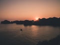 Beautiful sunset, fishing boat, rocky islands