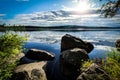 Beautiful sunset in forest mountain landscape. Lake and rocks in foreground. Angersjon between Hudiksvall and Soderhamn in Sweden