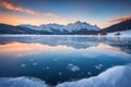 Beautiful sunset, a frozen lake and snow-capped mountains. Royalty Free Stock Photo