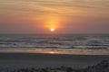 Beautiful sunset with golden light and dramatic sky over the beach of the atlantic ocean. Royalty Free Stock Photo