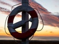 Beautiful sunset. golden, orange, blue colors over the sea. sky full of many colors. Life buoy in the foreground Royalty Free Stock Photo