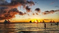 Beautiful sunset with golden sun clouds and sailing boats in the sea in Boracay island Philippines