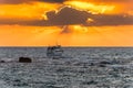 Beautiful sunset and golden twilight, and clouds and a longly cruise ship sailing on the Mediterranean Sea in Tel Aviv, Israel Royalty Free Stock Photo