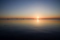 Beautiful sunset in harbour at the Aegean sea, Thessaloniki, Greece. Seascape and shore. Golden sunset at the sea with soft waves. Royalty Free Stock Photo