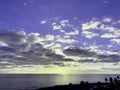 Beautiful sunset on the horizon above a calm ocean or sea. On the blue sky white clouds. view from hotel balcony Royalty Free Stock Photo