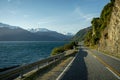 Beautiful sunset image of the Haast Pass road with Wanaka Lake on the left and snow capped mountains in the background on a winter Royalty Free Stock Photo