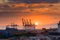Beautiful sunset and industrial cargo cranes in Manila bay