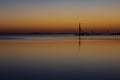 Beautiful sunset in the lagoon. Calm water simulates a mirror.