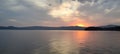 Beautiful sunset on the lake with clouds going into the horizon