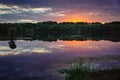 A beautiful sunset at a lake. Orange and purple clouds reflecting in the water. Germany, Baden-Wuerttemberg Royalty Free Stock Photo