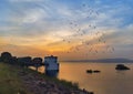 A beautiful Sunset at lakeside with flying birds