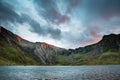 Beautiful sunset landscape image of Llyn Idwal and Devil`s Kitch
