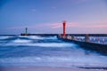 Sunset with lighthouse and blue clouds over the sea Royalty Free Stock Photo