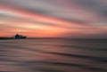 Colorful sea front view sunset with yacht at the horizon line, motion blur effect with clods and wave. Vacation time to relax and Royalty Free Stock Photo