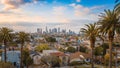 Beautiful sunset of Los Angeles downtown skyline and palm trees Royalty Free Stock Photo