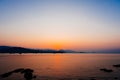 Beautiful sunset with mountain and speed boat, yacht at pier over horizon summer sea in evening background. Royalty Free Stock Photo