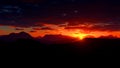 Beautiful sunset in the mountains. Sun in the clouds over the mountains Royalty Free Stock Photo