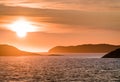 Beautiful Sunset with mountains and icebergs. Arctic circle and ocean. Sunrise horizon with pink sky during midnight sun