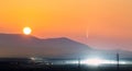 Beautiful sunset in mountains with Neowise comet with light tail in dark evening sunset sky Royalty Free Stock Photo