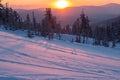 Beautiful sunset in the mountains. Winter landscape with fir trees in the snow Royalty Free Stock Photo