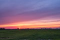Beautiful sunset with a multi coloured sky over a Dutch agricultural polder landscape Royalty Free Stock Photo
