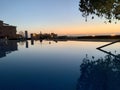 Beautiful sunset near apartment. tree reflection in swimming pool Royalty Free Stock Photo