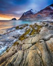 Beautiful sunset Norway landscape of picturesque stones on the arctic beach of cold Norwegian Sea Royalty Free Stock Photo