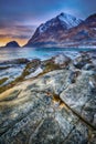 Beautiful sunset Norway landscape of picturesque stones on the arctic beach of cold Norwegian Sea Royalty Free Stock Photo