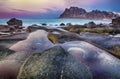 Beautiful sunset Norway landscape of picturesque stones on the arctic beach of cold Norwegian Sea Royalty Free Stock Photo