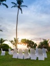 Beautiful sunset on the ocean. Chairs standing in row at wedding ceremony Royalty Free Stock Photo