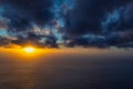 Beautiful sunset at the ocean with fog on the horizon and dark clouds Royalty Free Stock Photo