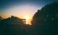 Beautiful sunset oceanic landscape, bench on the hill in garden overlooking the ocean