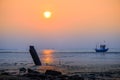 Beautiful sunset with old rusty fishing boat parked on a sandy