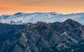 Beautiful sunset with orange tones in the sky and Sierra Nevada snowcapped mountain range