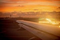 Beautiful sunset over the airport from a plane window on taking off Royalty Free Stock Photo