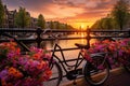 Beautiful sunset over Amsterdam canals with bicycles and colorful flowers. Beautiful sunrise over Amsterdam, The Netherlands, with Royalty Free Stock Photo