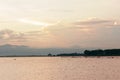 Beautiful sunset over calm lake with cloudy sky in Thailand Royalty Free Stock Photo