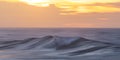 Beautiful sunset over calm ocean and lazy wave