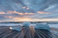 Beautiful sunset over famous Diamond beach, Iceland. This sand lava beach is full of many giant ice gems, glacier lagon