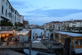 Beautiful sunset over the Grand Canal in Venice near the Railway station with a view to a ferry pier and restaurants. Royalty Free Stock Photo