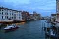 Beautiful sunset over the Grand Canal in Venice near the Railway station with a view to a ferry pier and restaurants. Royalty Free Stock Photo