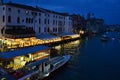 Beautiful sunset over the Grand Canal in Venice near the Railway station with a view to a ferry pier and restaurants. Royalty Free Stock Photo