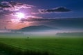 Beautiful sunset over green field. Royalty Free Stock Photo