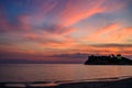 Beautiful sunset over an idyllic sandy beach and dramatic cliff face